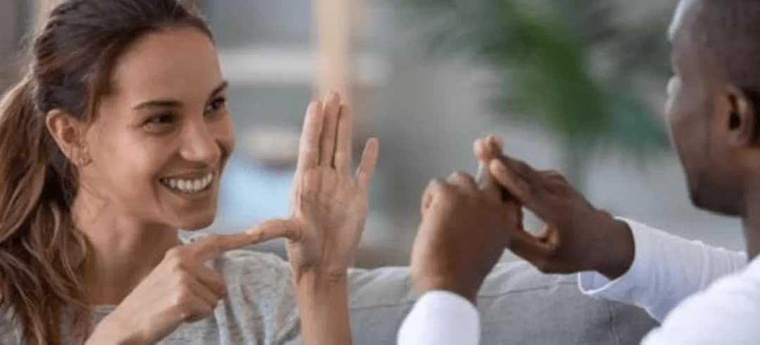 two people communicating in sign language